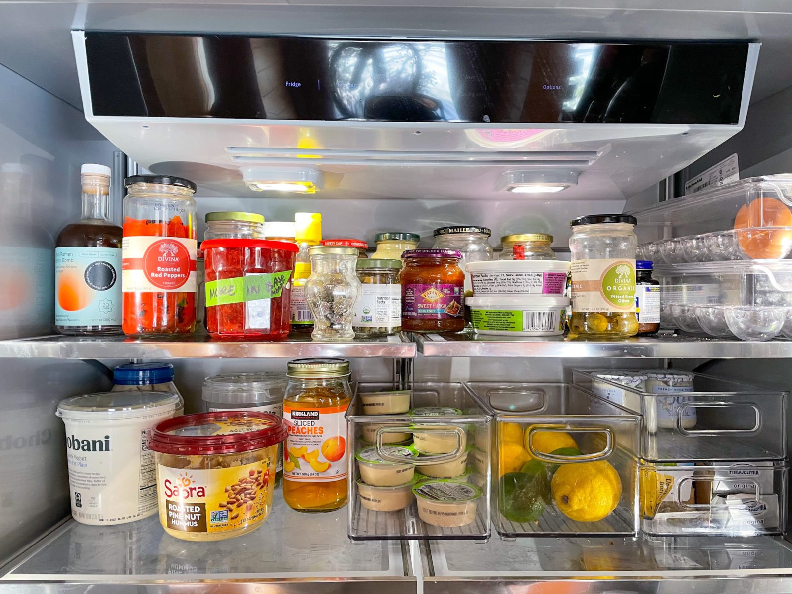 Fridge organization. Two shelves stocked with cooking ingredients.