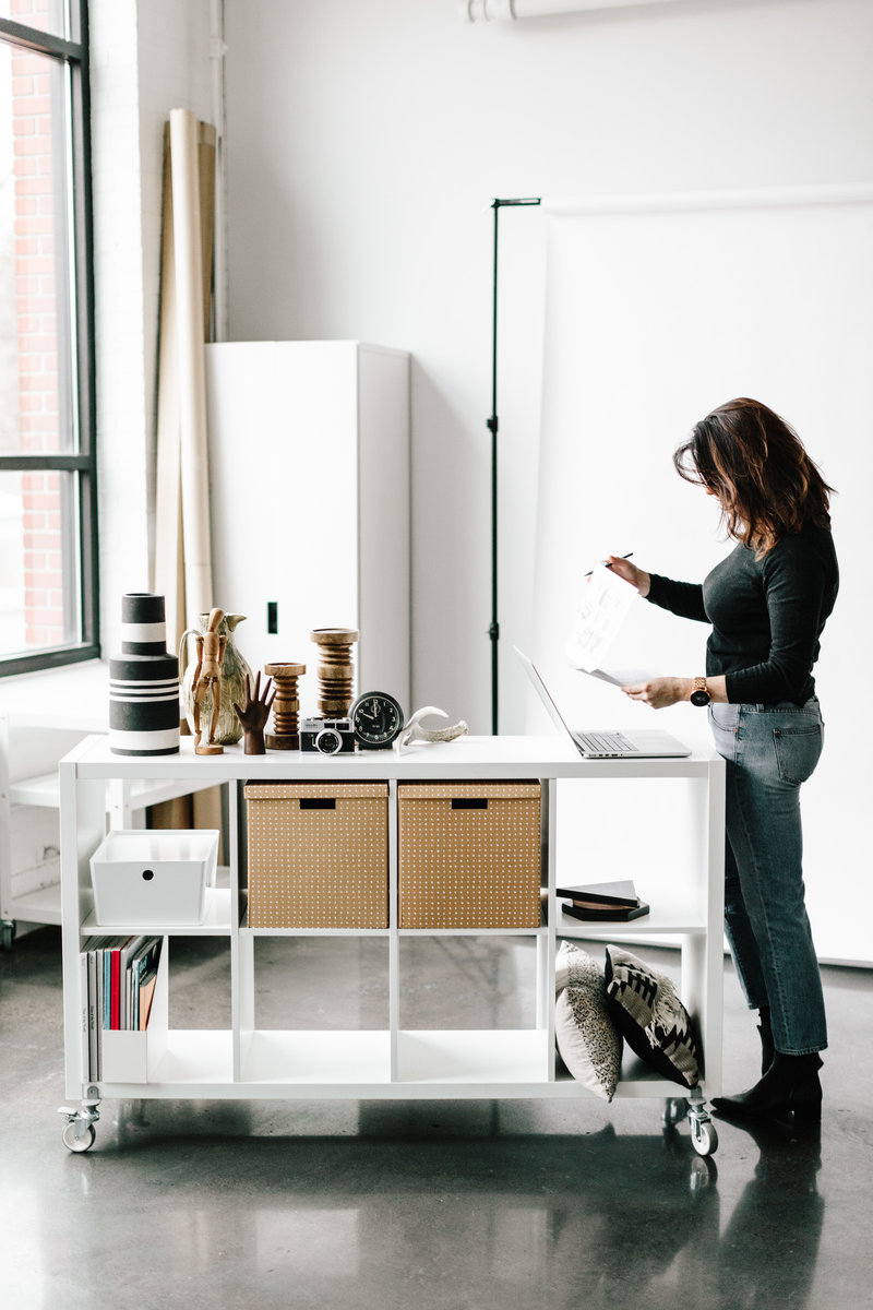 Woman standing working  in front of a laptop at a mobile desk