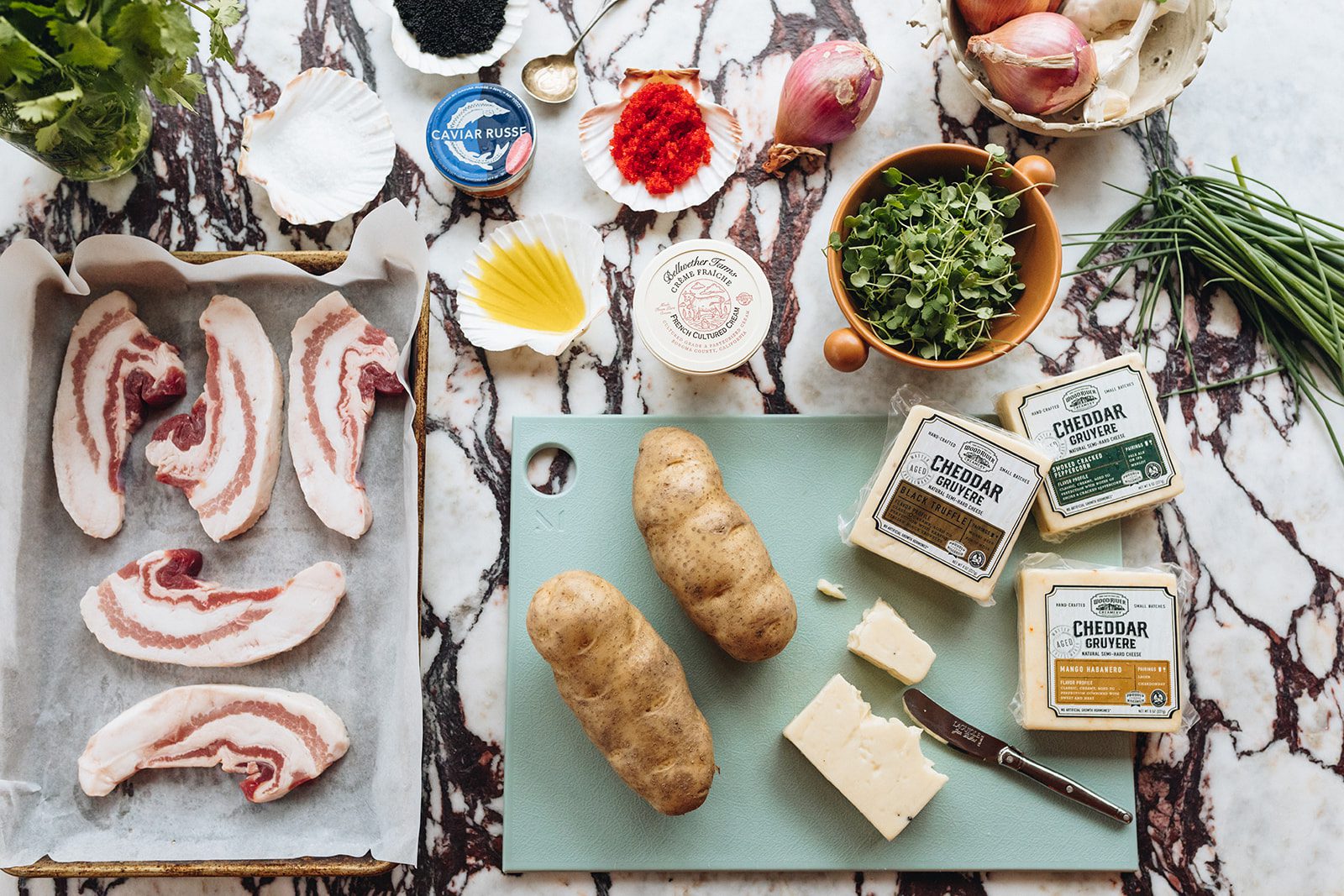 Loaded Baked Potato ingredients on a marble countertop