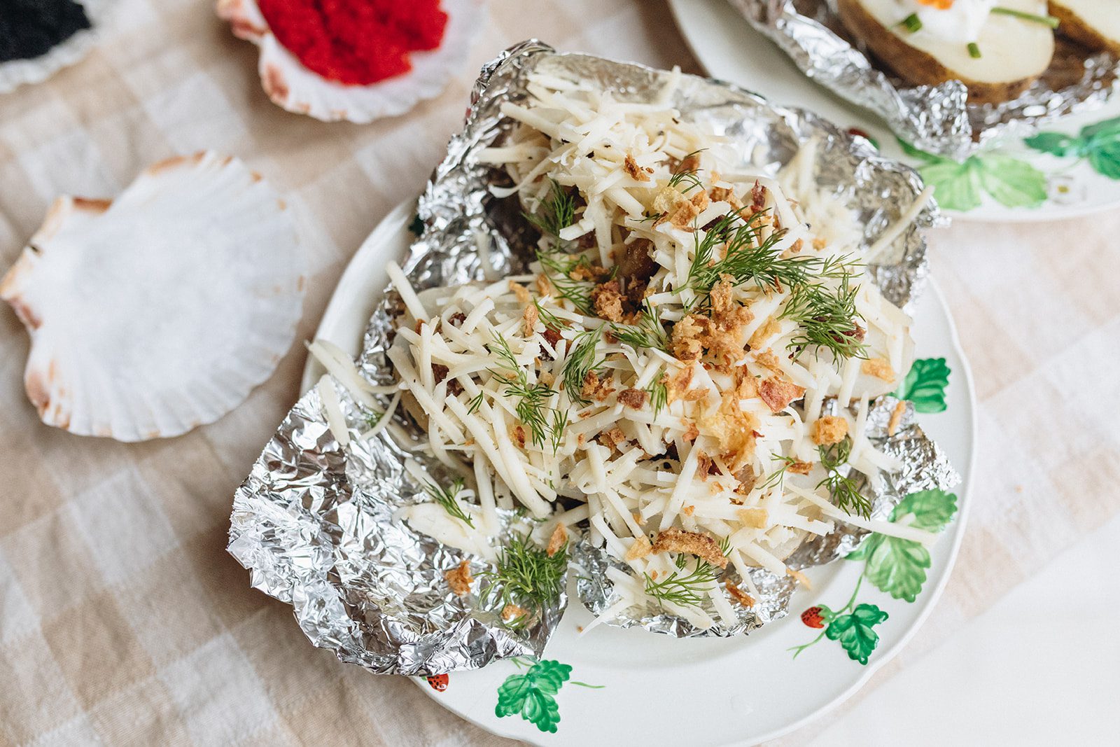 A baked potato with Smoked Cracked Peppercorn, Crispy Pork Belly and Green Onions